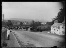 [Street scene with mounted soldiers]