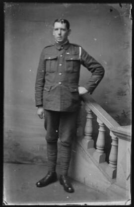 [Soldier with wound stripe, good conduct stripes, medal ribbon and overseas service chevrons.]