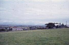 Looking SE towards Llanfaethlu : village & Snowdonia range from Llanfaethlu ch.