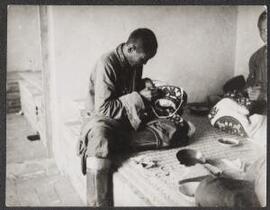 [Mongolian tailor at work]